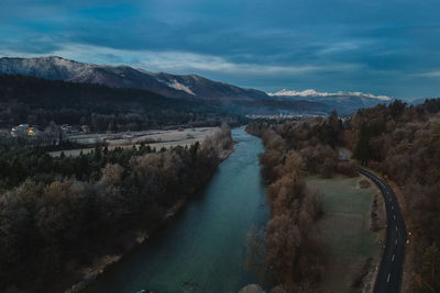 High angle view of river amidst mountains against sky