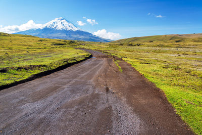 Country road leading to snowcapped mountain