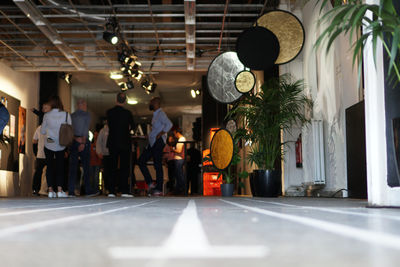 People walking in illuminated room