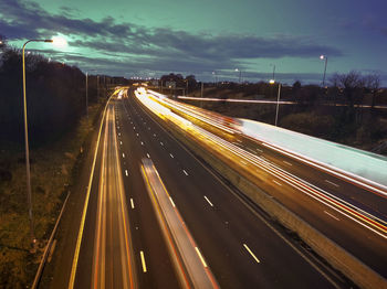 High angle view of light trails on highway at night