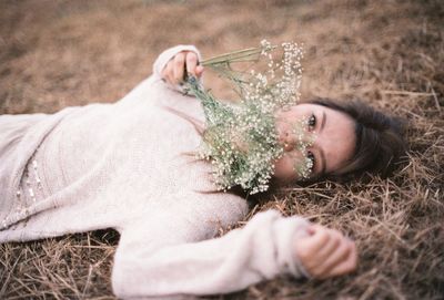 Close-up of a young woman lying on ground