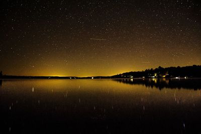 Scenic view of lake against sky at night