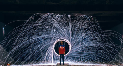 Light trails on illuminated ferris wheel at night