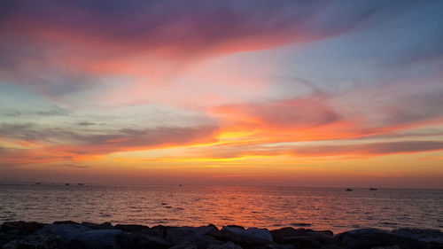 Scenic view of sea against romantic sky at sunset