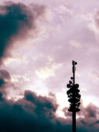 Low angle view of street light against cloudy sky