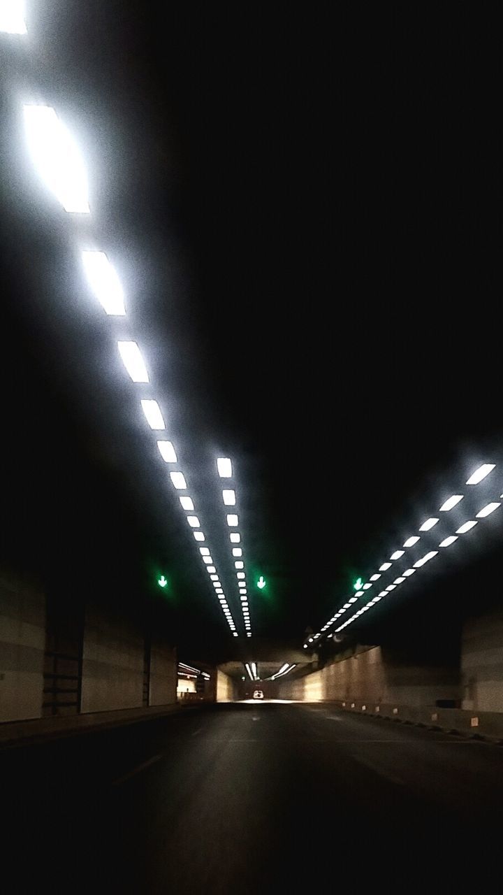illuminated, night, lighting equipment, transportation, the way forward, architecture, built structure, diminishing perspective, light - natural phenomenon, street light, road, indoors, connection, electric light, vanishing point, bridge - man made structure, city, street, tunnel, no people