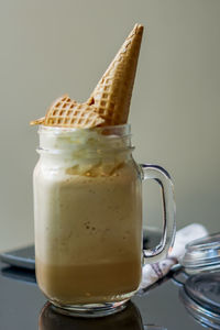 Cold coffee with whipped cream and waffle cone