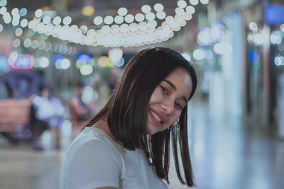 Portrait of smiling woman at night