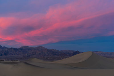 Scenic view of desert against sky during sunset