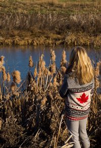 Rear view of woman standing in field
