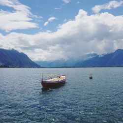 Fishing boat in sea against sky