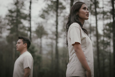 Portrait of teenage girl looking away in forest