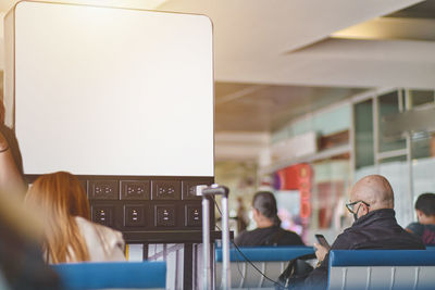 Rear view of woman sitting in cafe