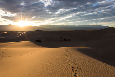 Scenic view of desert against sky during sunset