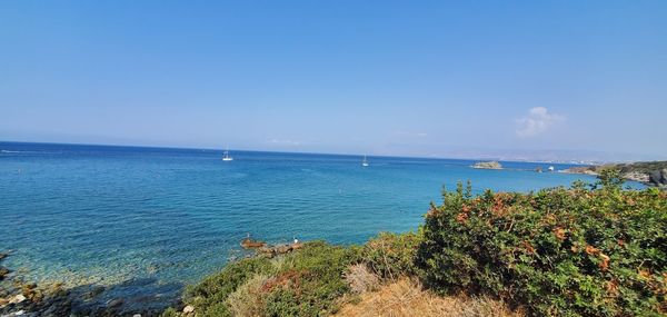 Scenic view of sea against blue sky