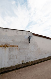 Broken concrete wall on roadside