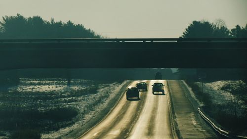 Bridge over road during sunset