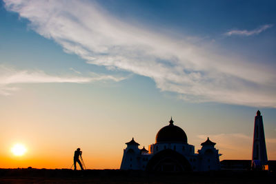 Silhouette strait of malacca mosque against sky during sunset