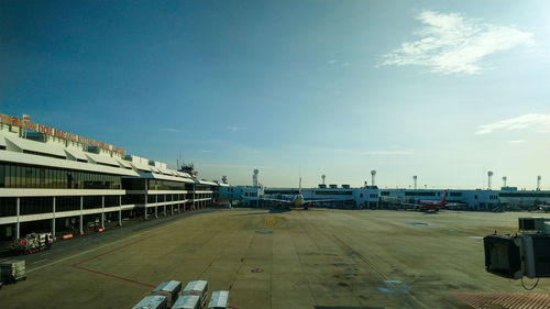 Airplane on airport runway against sky