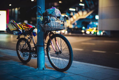 Bicycle parked on street at night