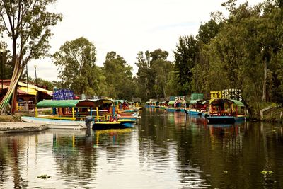 Boats moored in lake against sky