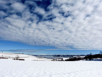 Scenic view of landscape against sky during winter