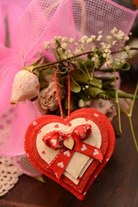 Close-up of red rose on table