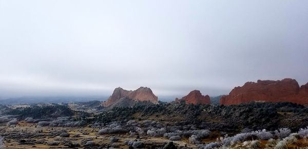 Rock formations on landscape against sky