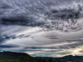 Scenic view of landscape against dramatic sky