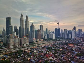 View of skyscrapers against cloudy sky