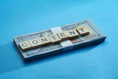 High angle view of information sign on table against blue background