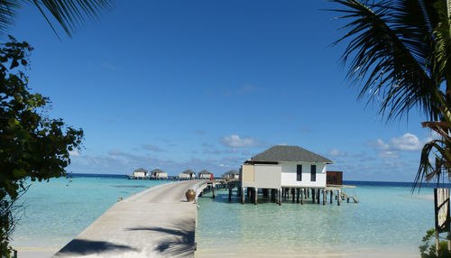 View of swimming pool by sea against sky