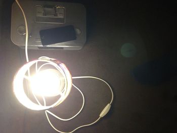 High angle view of illuminated light bulb on table