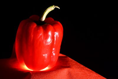 Close-up of red bell pepper against black background
