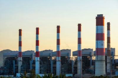 Buildings in city against clear sky. coal power plant.