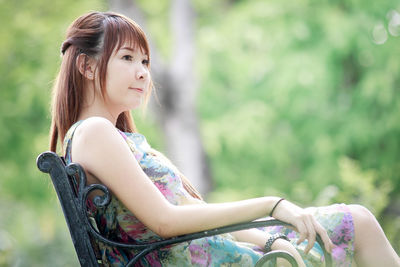 Portrait of young woman looking away outdoors