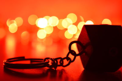 Close-up of illuminated lamp on table