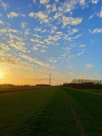 Scenic view of field against sky during sunset