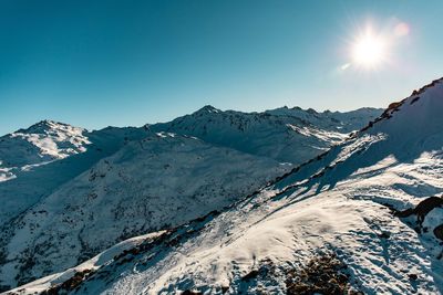 Scenic view of snowcapped mountains against clear sky