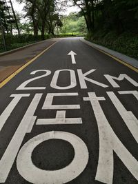 Close-up of road sign against sky