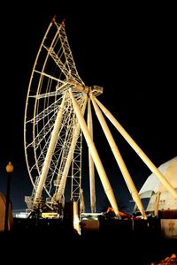 Low angle view of ferris wheel at night