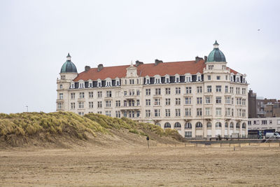 Buildings against sky on beach