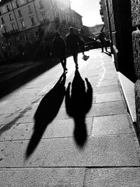 Shadow of people on city street