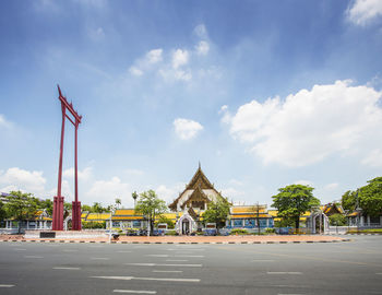 Road by building against sky