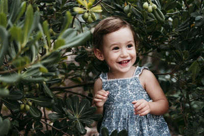 Portrait of a smiling girl standing outdoors