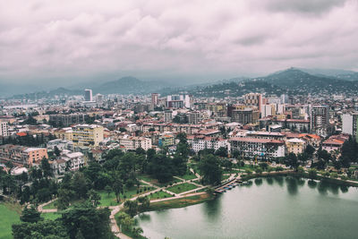 High angle view of river amidst buildings in city against sky