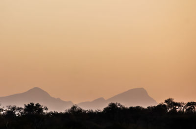 Scenic view of silhouette mountains against sky during sunset