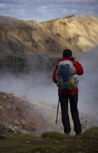 Woman stopping to admire the view on laugavegur hiking trail
