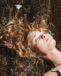 Close-up of woman lying by plants