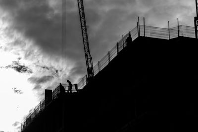 Low angle view of building against cloudy sky